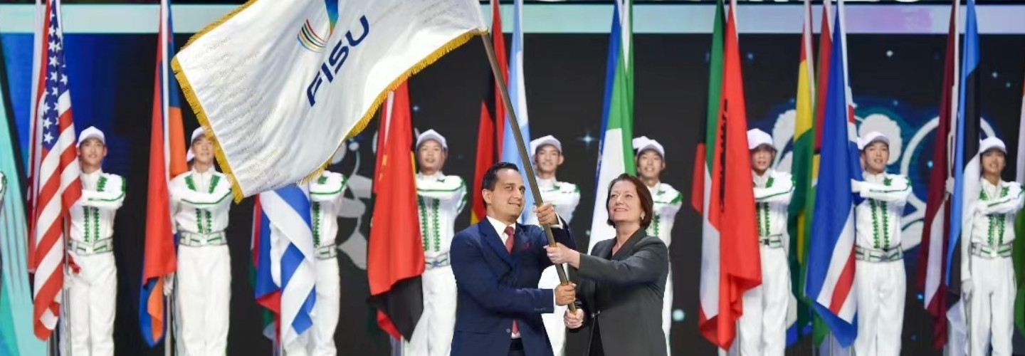 Flaggenübergabe - Für Deutschland nahmen Mahmut Özdemir, Parlamentarischer Staatssekretär bei der Bundesministerin des Innern und für Heimat, sowie Dr. Verena Burk, Senior-Mitglied des FISU Exekutivkomitees und Akademische Oberrätin an der Universität Tübingen, die Flagge entgegen.